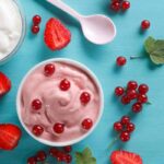 su un tavolo gelato allo yogurt, frutta e un cucchiaino